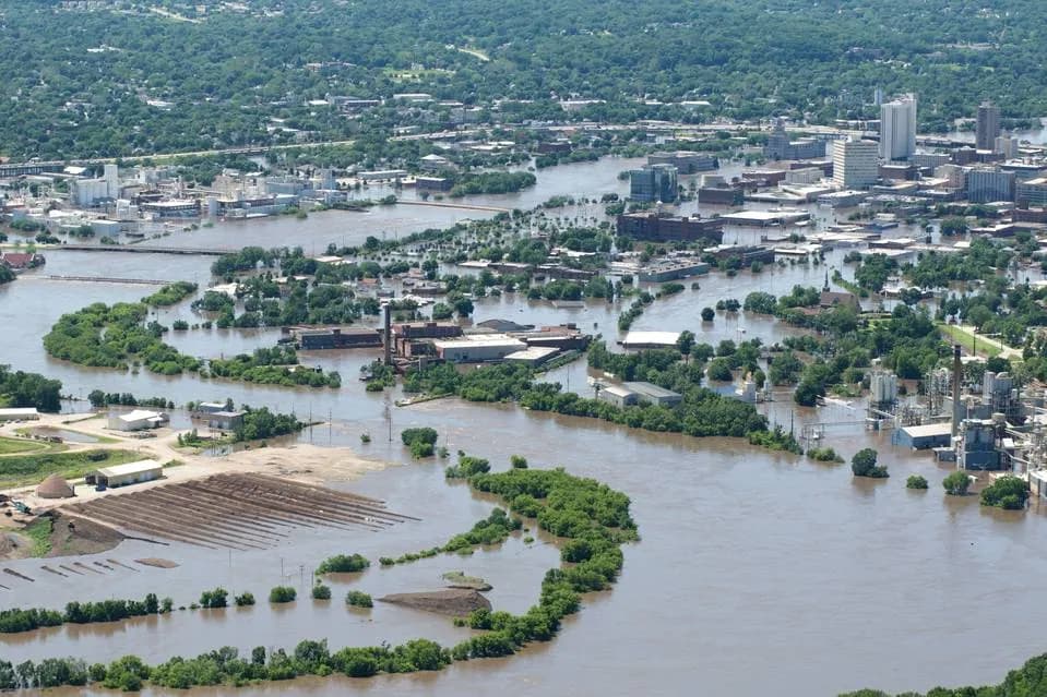 Aerial view of a Cedar Rapids riverfront neighborhood and industrial district submerged under floodwater