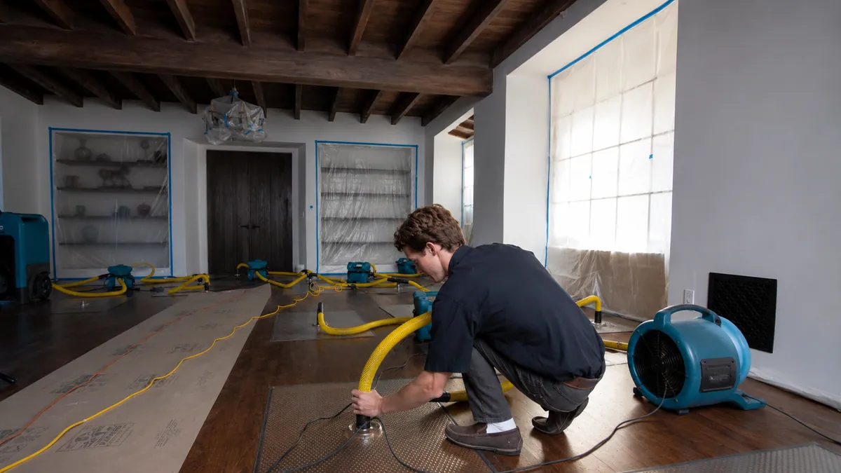 Industrial air movers running on a wet floor during a water extraction job